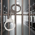 handcuffs on jail cell closed metal bar door pris 2022 04 19 22 54 03 utc